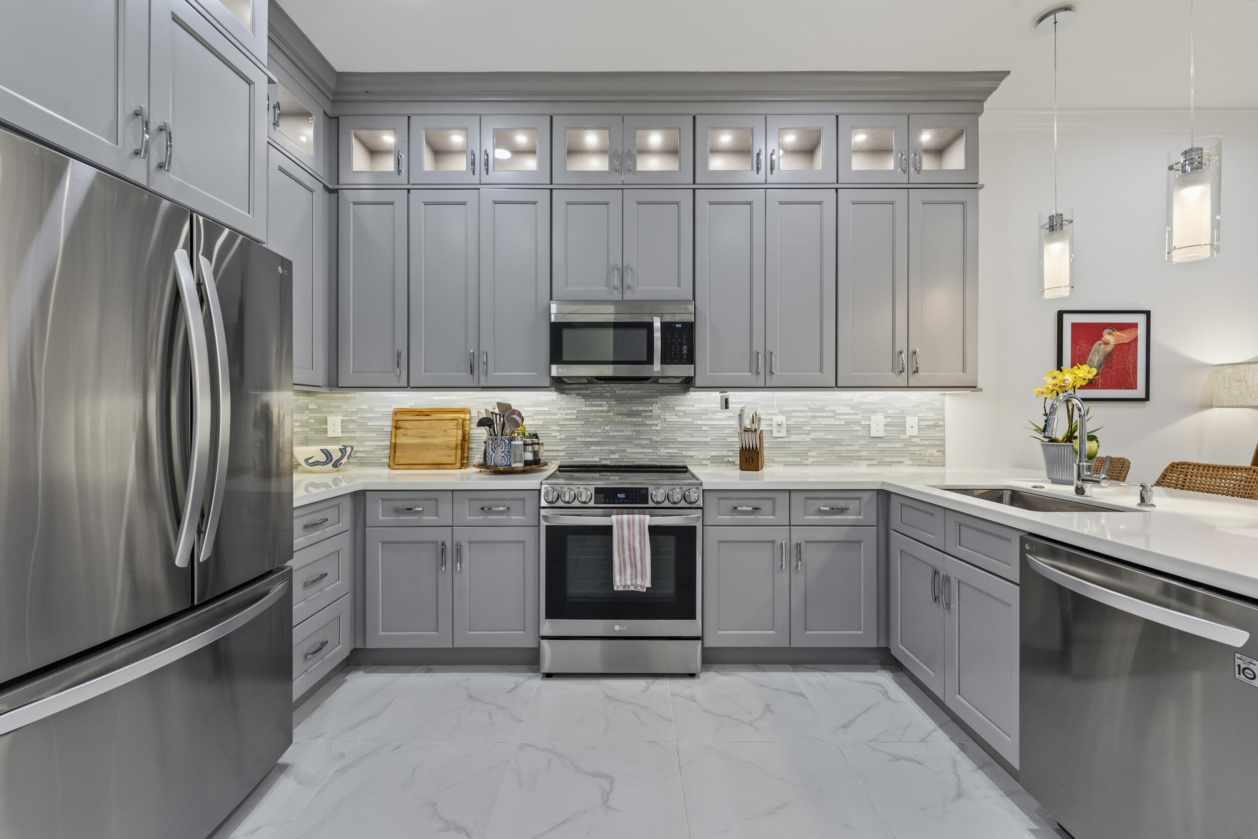 4692 Southeast Manatee Terrace Stuart, FL 34997 - Photo 6 of 47 a kitchen with stainless steel appliances a stove sink and refrigerator