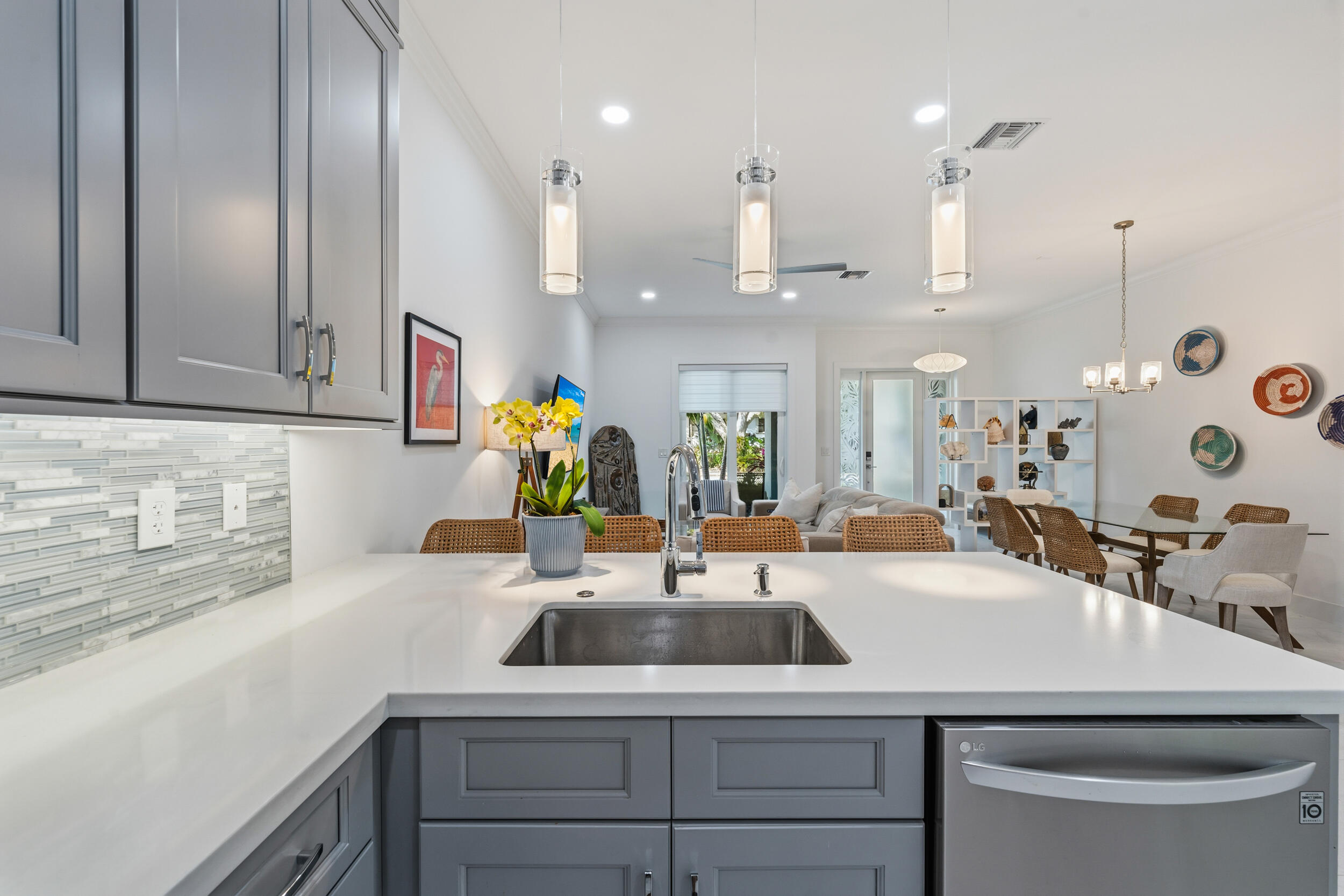 4692 Southeast Manatee Terrace Stuart, FL 34997 - Photo 8 of 47 a kitchen with a sink a counter space and cabinets