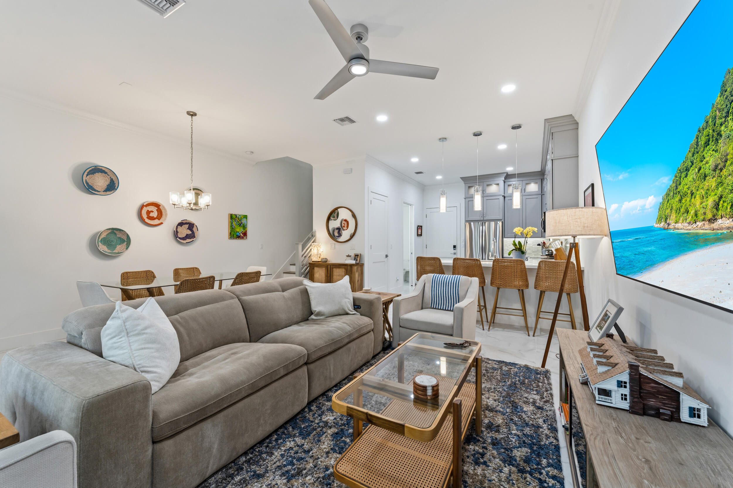 4692 Southeast Manatee Terrace Stuart, FL 34997 - Photo 9 of 47 a living room with furniture and a chandelier