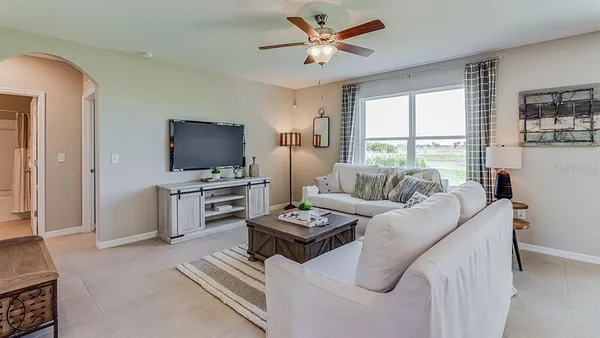 a living room with furniture and a flat screen tv