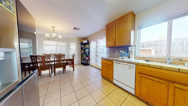 a kitchen with lots of counter top space and dining table