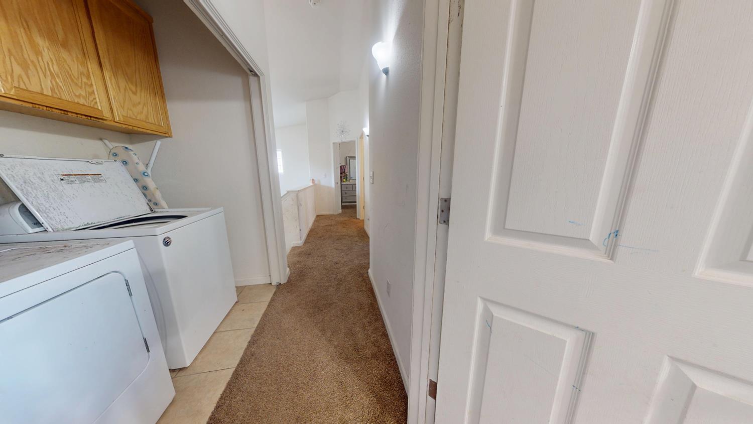 185 River Pointe Madera, CA 93637 - Photo 16 of 36 a view of a hallway with washer and dryer
