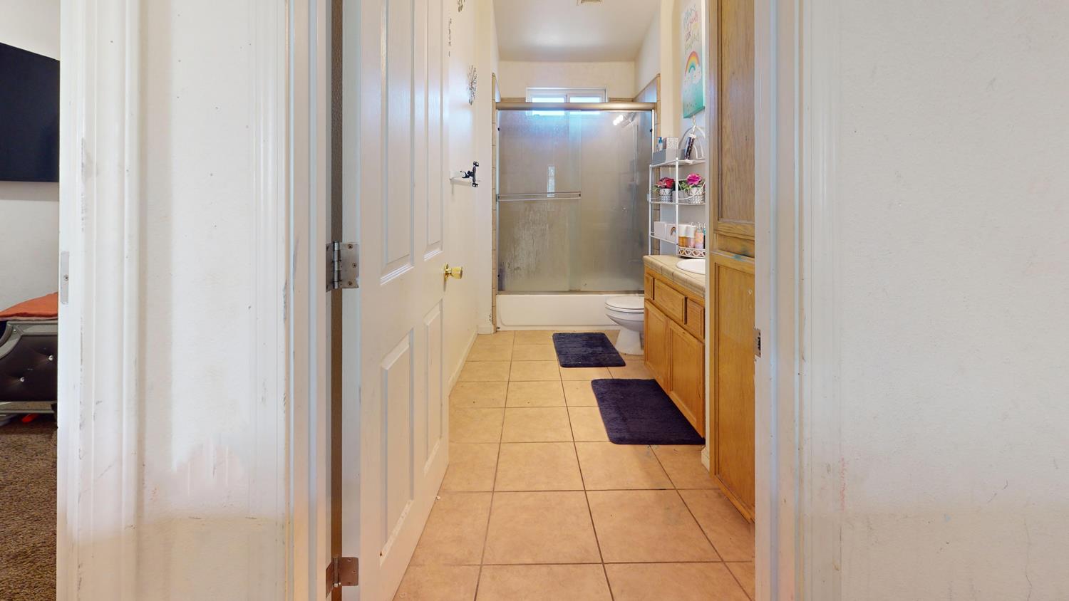 185 River Pointe Madera, CA 93637 - Photo 17 of 36 a bathroom with a glass door shower