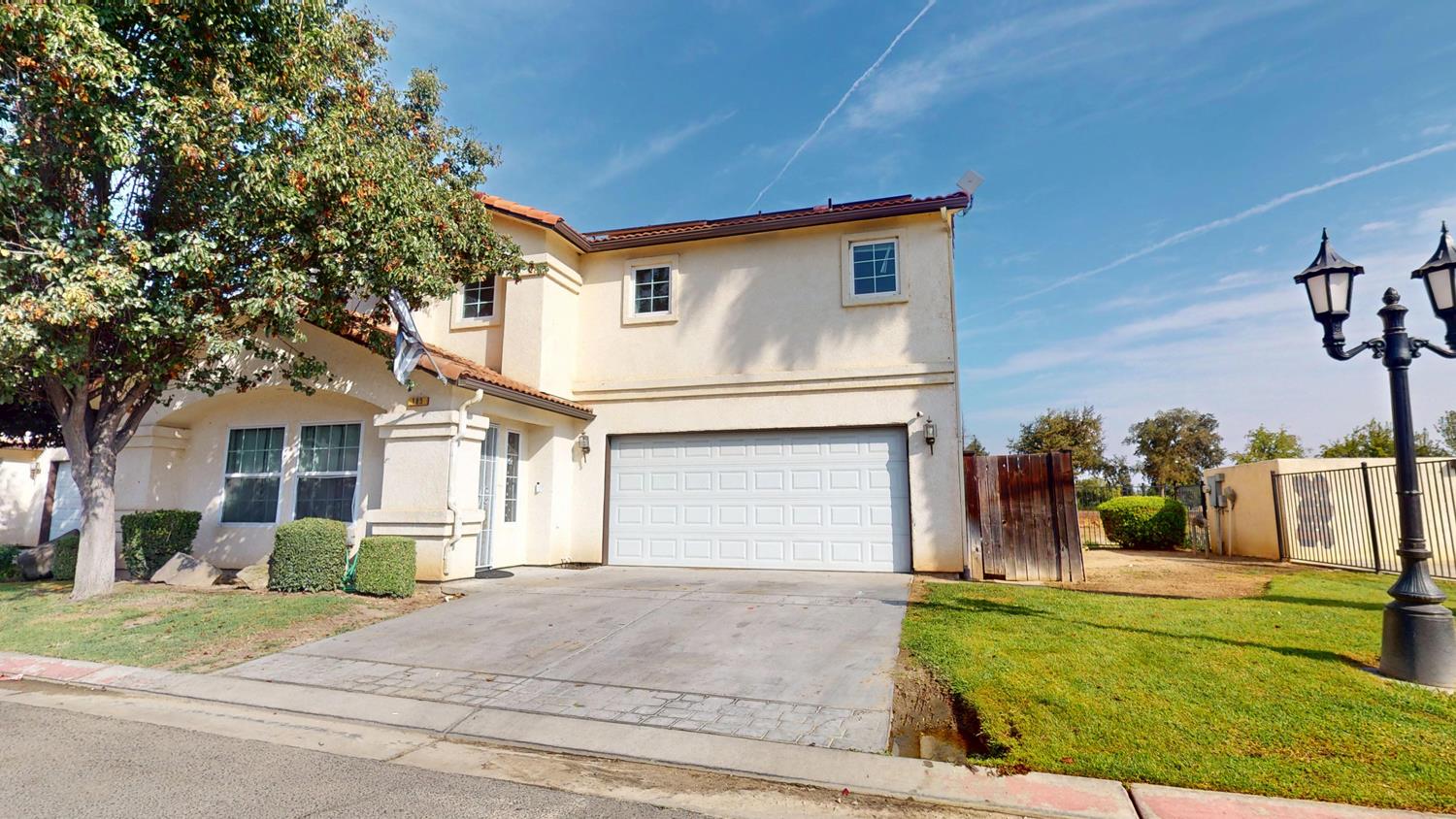 185 River Pointe Madera, CA 93637 - Photo 2 of 36 a view of a white house with a big yard and large tree