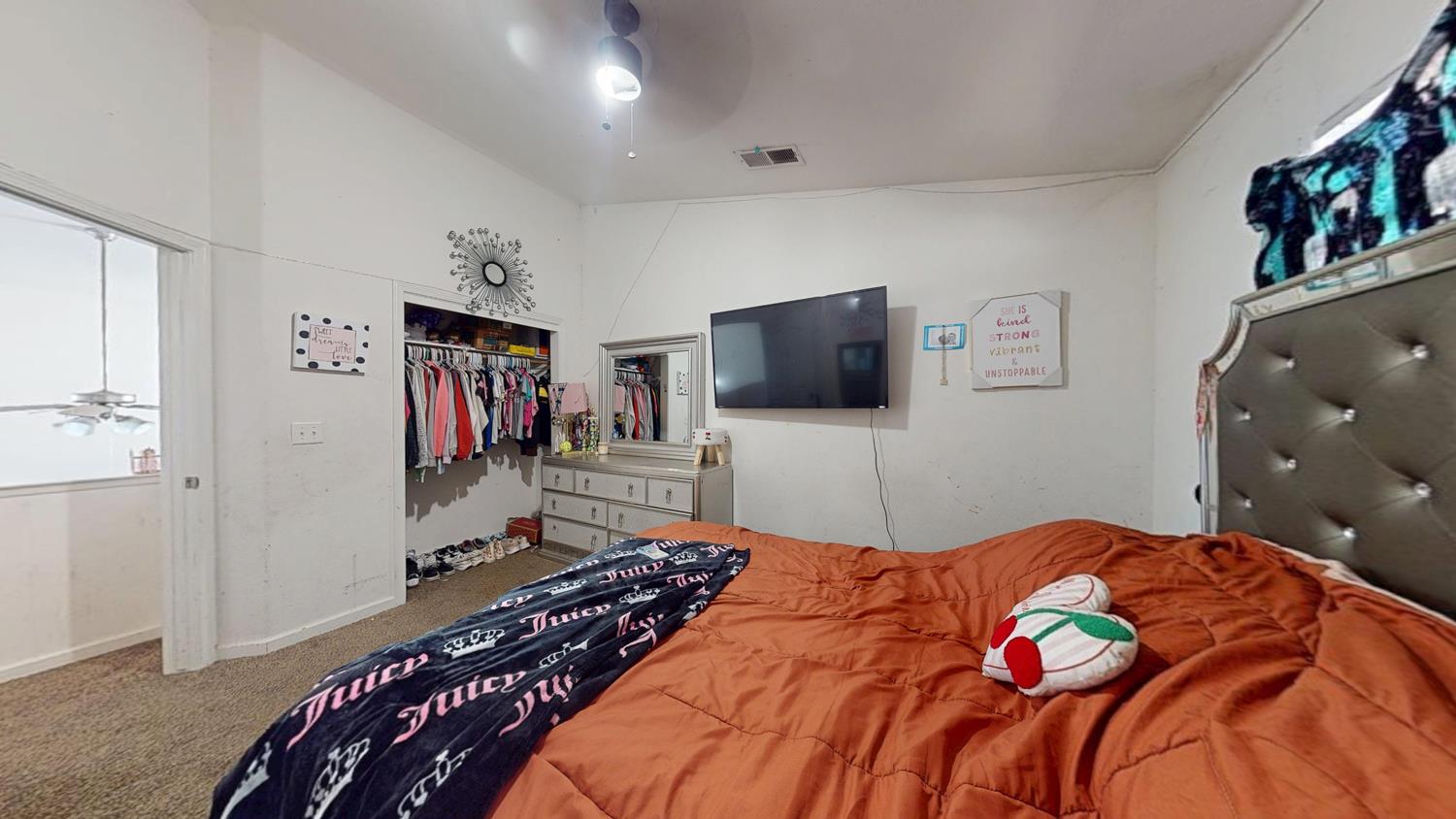 185 River Pointe Madera, CA 93637 - Photo 22 of 36 a bedroom with a bed and a flat screen tv