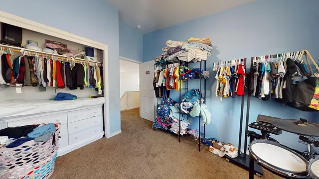 a view of walk in closet with clothes
