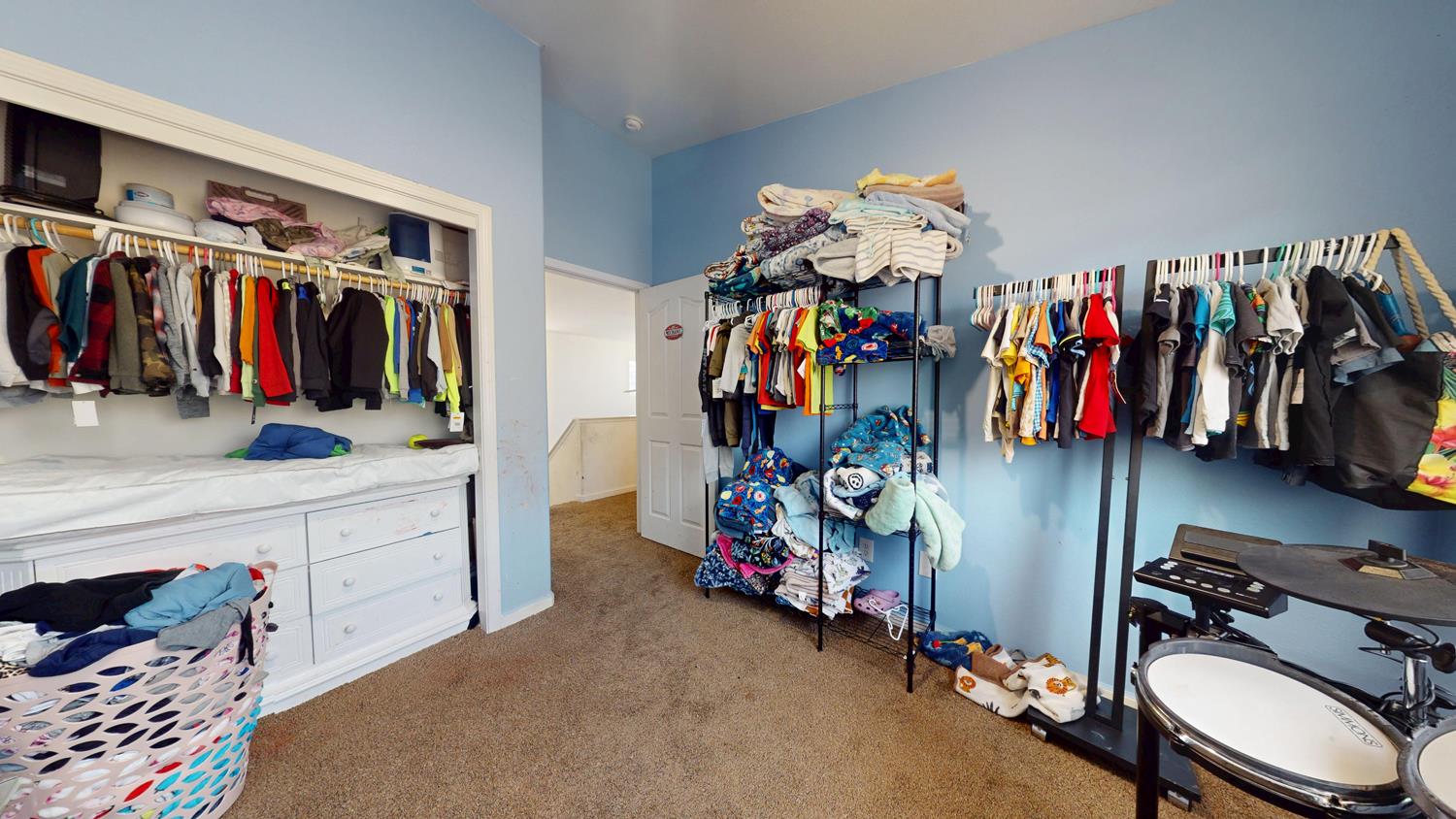 185 River Pointe Madera, CA 93637 - Photo 24 of 36 a view of walk in closet with clothes