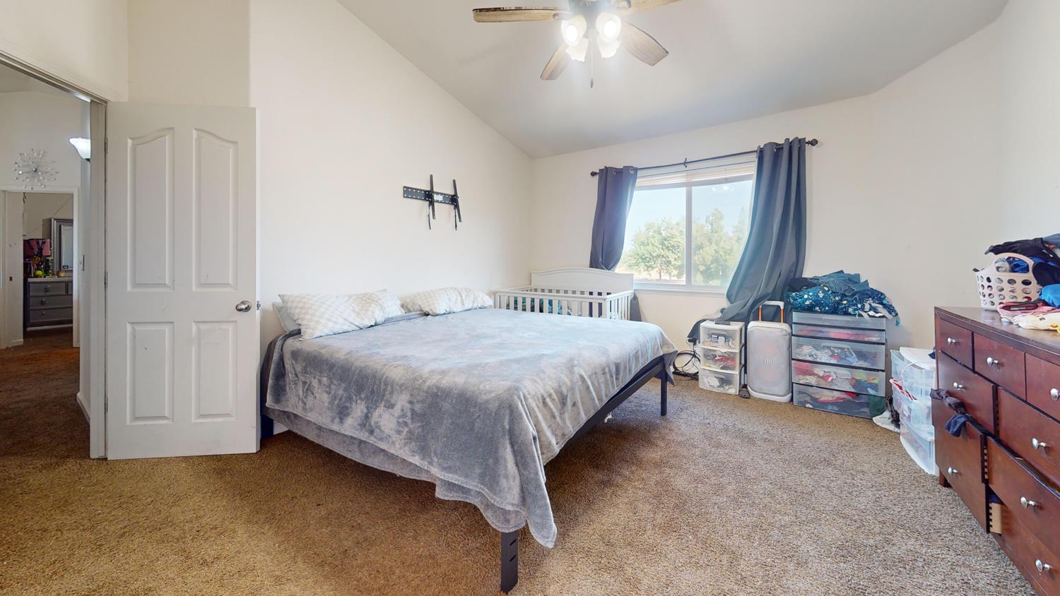 185 River Pointe Madera, CA 93637 - Photo 25 of 36 a bedroom with a bed dresser and a window