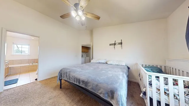 a bedroom with a bed and a chandelier