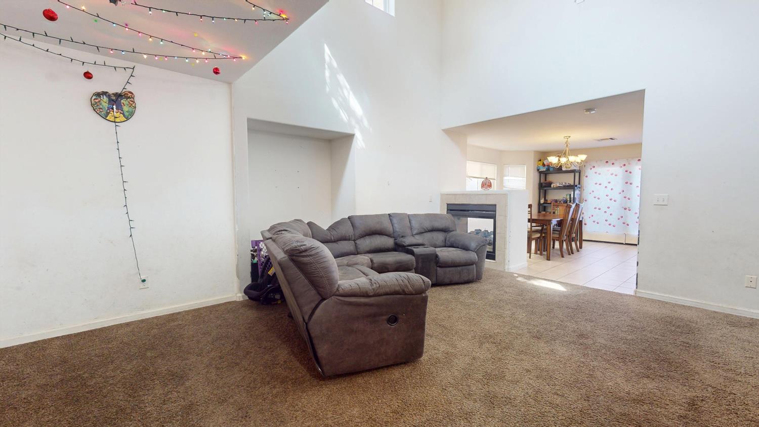 185 River Pointe Madera, CA 93637 - Photo 4 of 36 a living room with furniture and a dining table