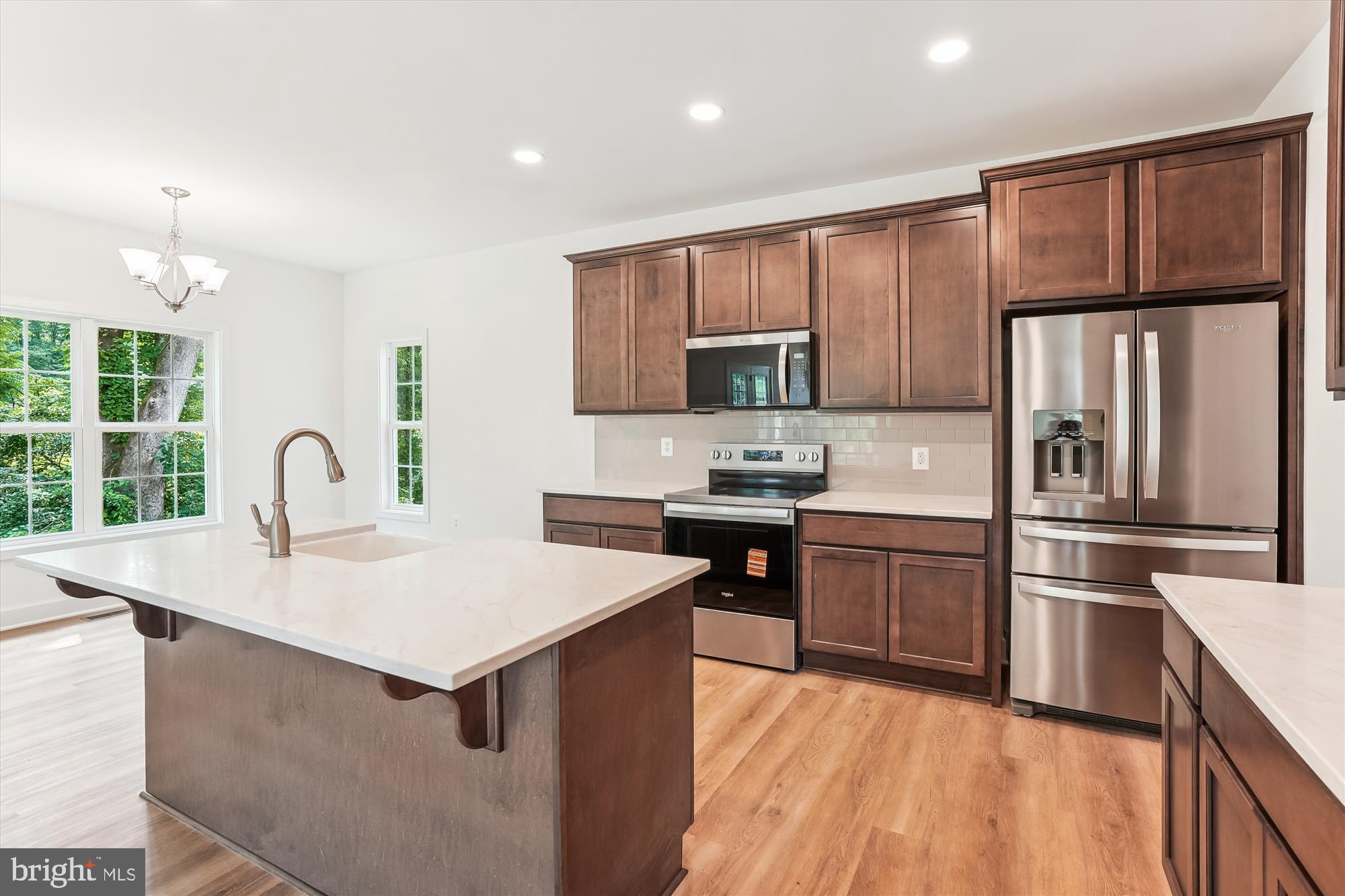 13053 Korea Road Amissville, VA 20106 - Photo 12 of 66 a kitchen with kitchen island a counter top space a sink stainless steel appliances and cabinets