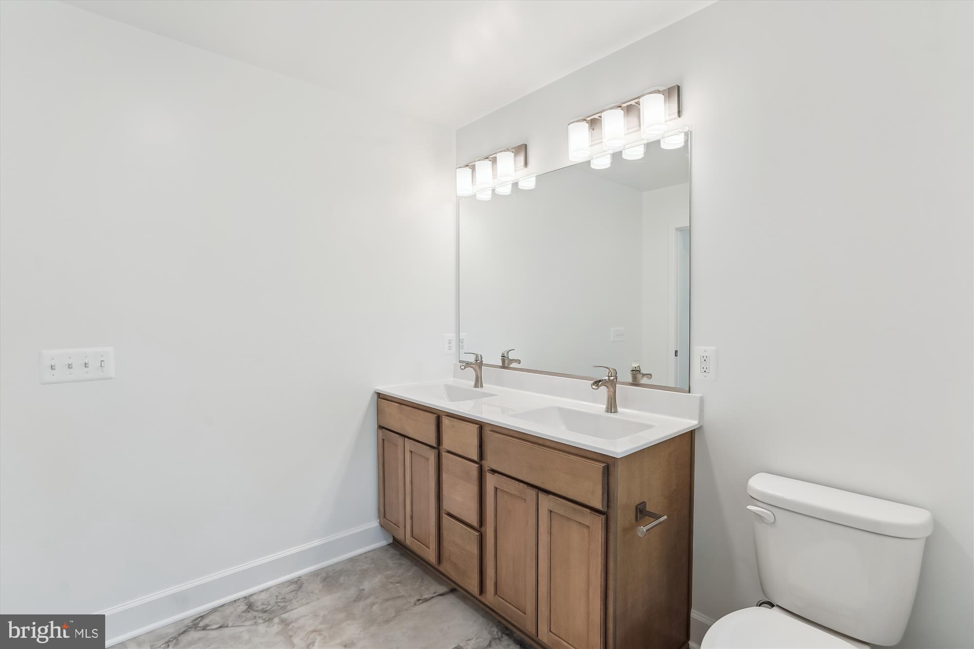 13053 Korea Road Amissville, VA 20106 - Photo 52 of 66 a bathroom with a toilet sink and mirror