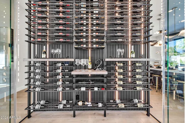 a bathroom with a granite countertop sink and a large mirror next to a window