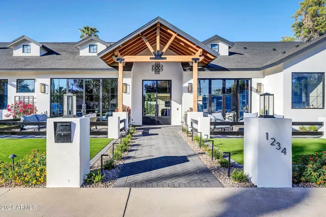 a view of a house with swimming pool and sitting area