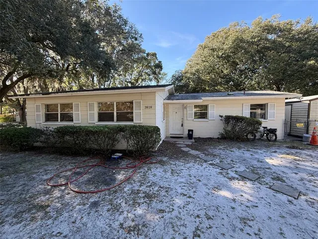 a view of a house with backyard and sitting area