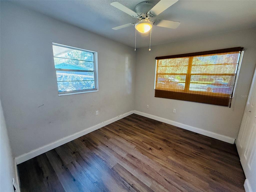 3818 Northeast 13th Drive Gainesville, FL 32609 - Photo 11 of 12 a view of an empty room with wooden floor and a window