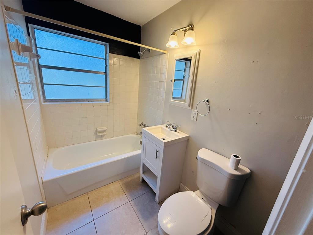 3818 Northeast 13th Drive Gainesville, FL 32609 - Photo 12 of 12 a bathroom with a sink a toilet and shower