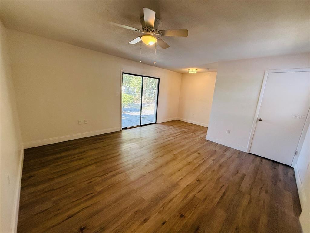 3818 Northeast 13th Drive Gainesville, FL 32609 - Photo 3 of 12 wooden floor in an empty room with a window