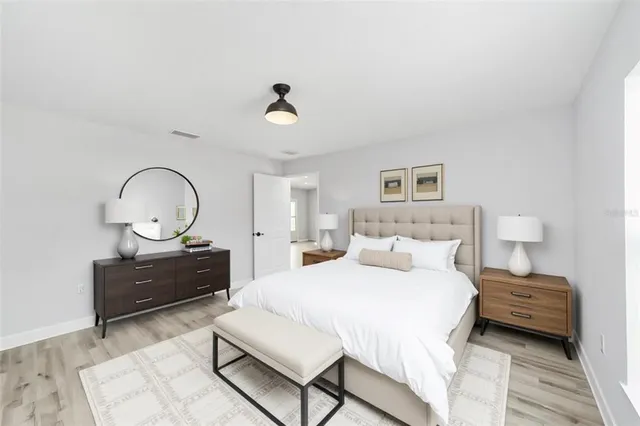 a bedroom with a bed window and a dresser