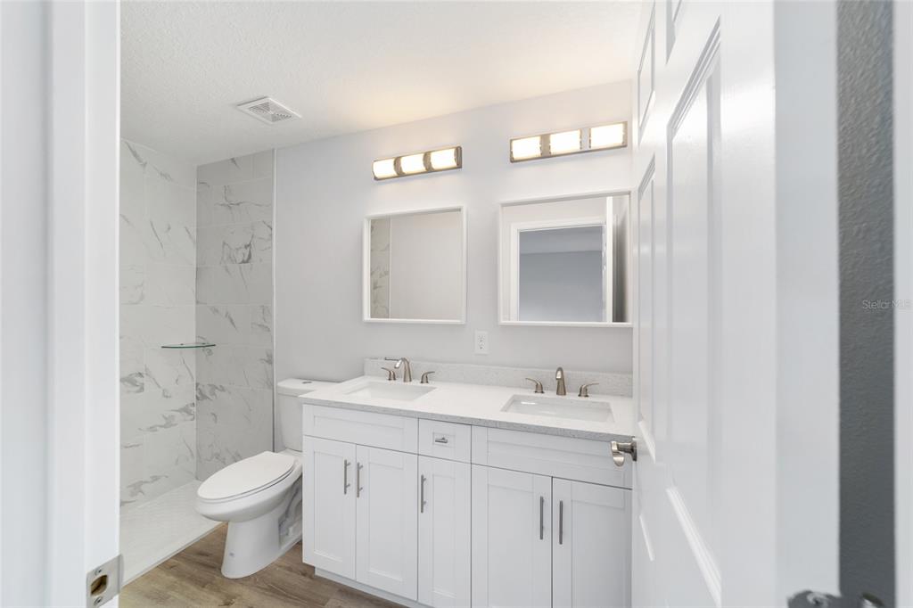 2871 Southwest 147th Terrace Ocala, FL 34481 - Photo 24 of 44 a bathroom with a toilet a sink and mirror