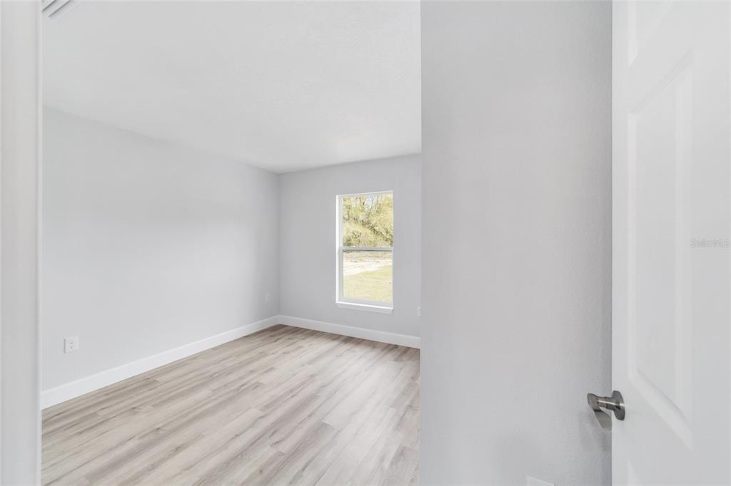2871 Southwest 147th Terrace Ocala, FL 34481 - Photo 33 of 44 a view of an empty room with wooden floor and window