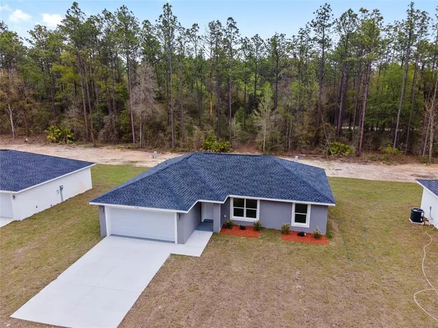 an aerial view of a house with swimming pool