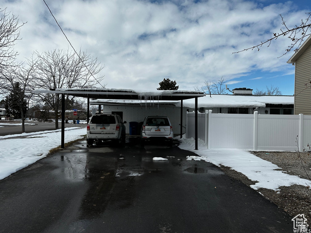 702 North 100 West Logan, UT 84321 - Photo 48 of 58 Exterior space with driveway, fence, and an attached carport