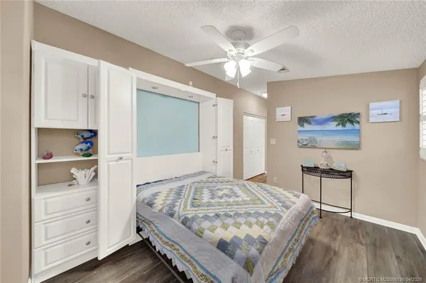 a bedroom with a bed and a chandelier