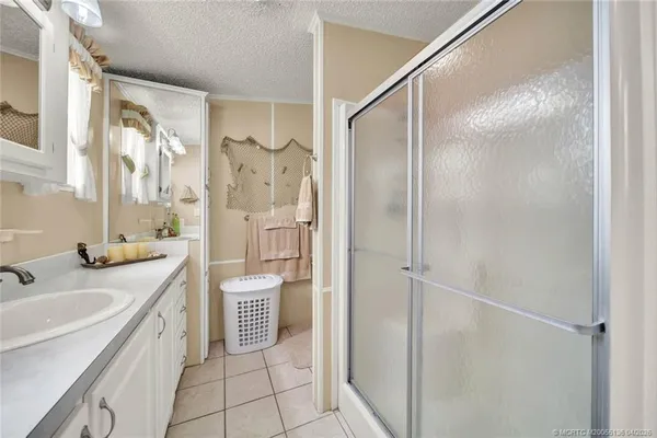 a spacious bathroom with a shower sink vanity and a mirror