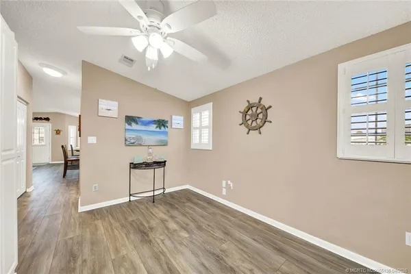 a view of livingroom with hardwood floor and a ceiling fan
