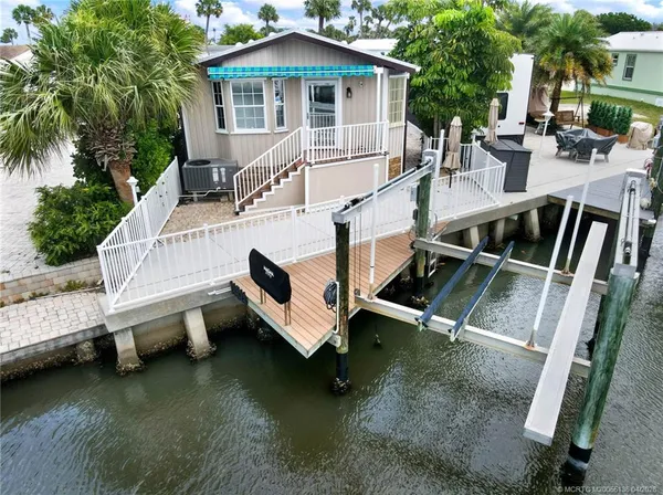 aerial view of a house with backyard and sitting area