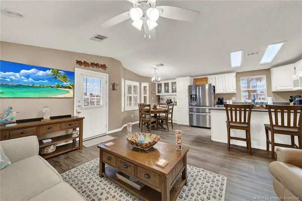 a living room with furniture and a kitchen view