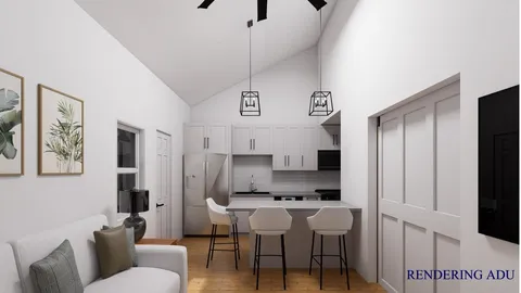 a living room with furniture and kitchen view