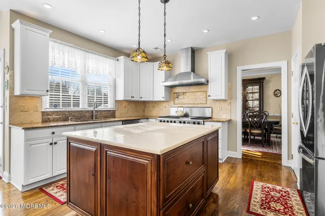 a living room with furniture a fireplace and a large window