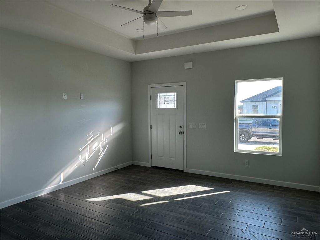 1605 Unity Drive Mercedes, TX 78570 - Photo 2 of 10 a view of an empty room with wooden floor and a window