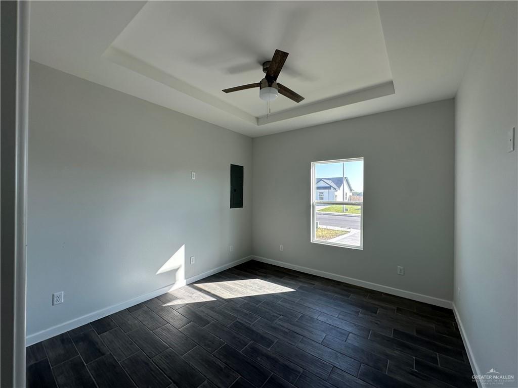 1605 Unity Drive Mercedes, TX 78570 - Photo 5 of 10 a view of an empty room with wooden floor and a window