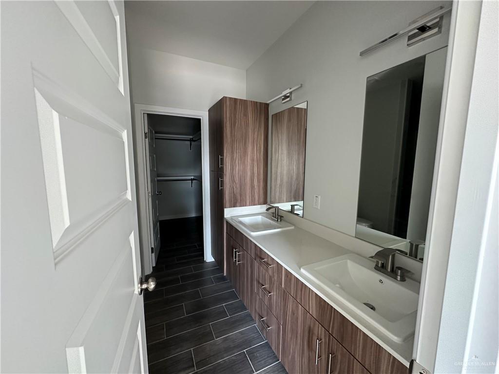 1605 Unity Drive Mercedes, TX 78570 - Photo 6 of 10 a bathroom with a double vanity sink and mirror