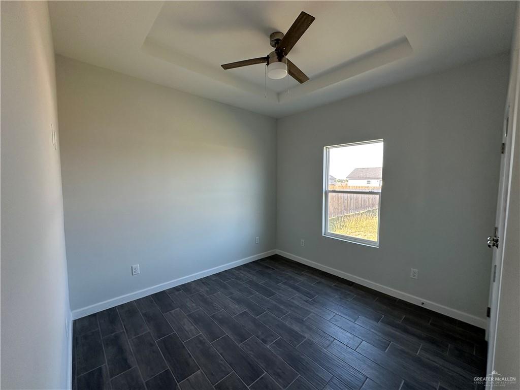 1605 Unity Drive Mercedes, TX 78570 - Photo 9 of 10 an empty room with a window and a ceiling fan