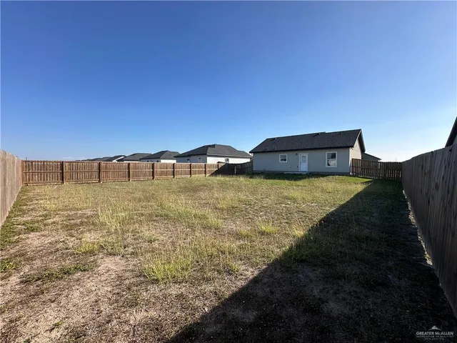 a view of a big yard with an outdoor seating