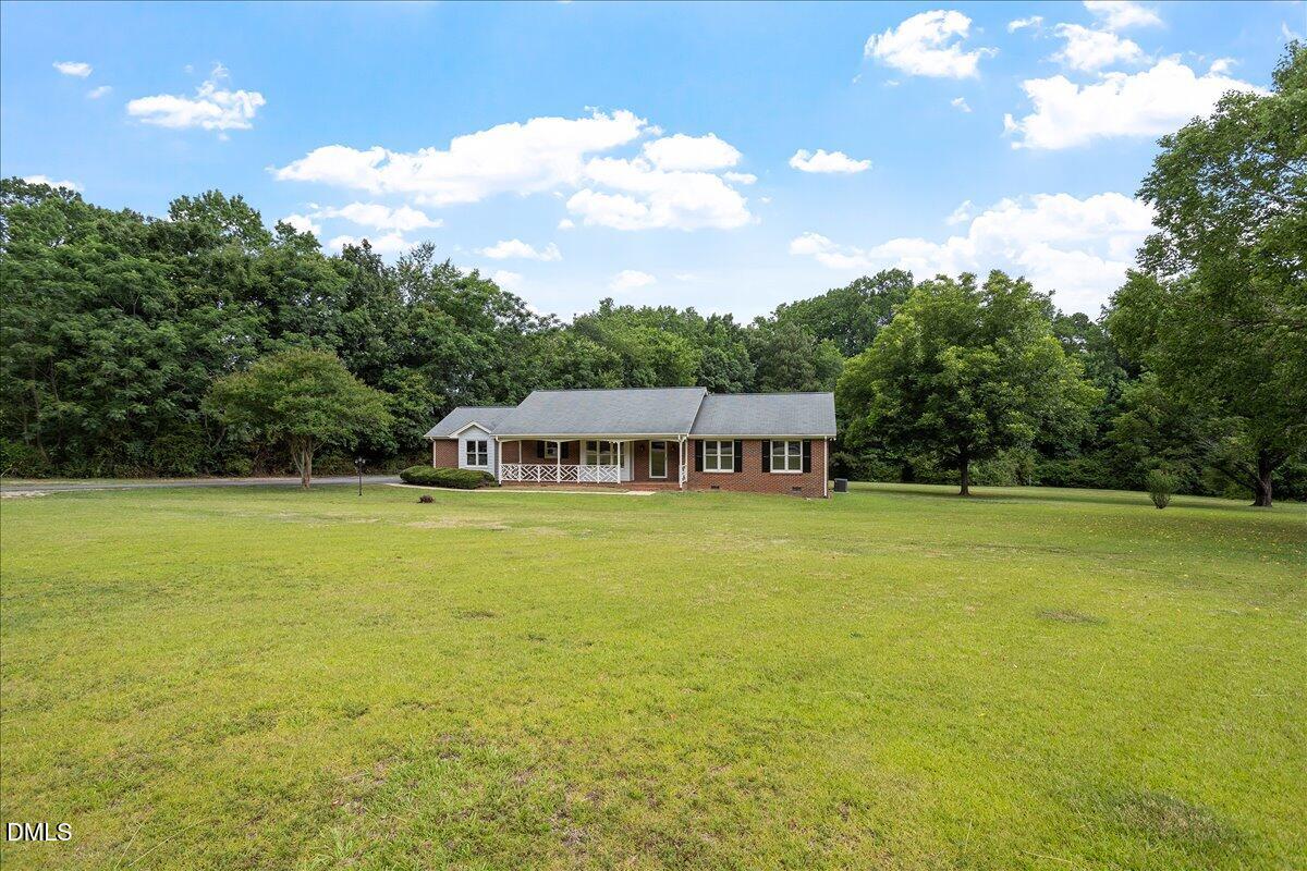 805 Rand Road Garner, NC 27529 - Photo 4 of 38 a front view of a house with swimming pool and green space