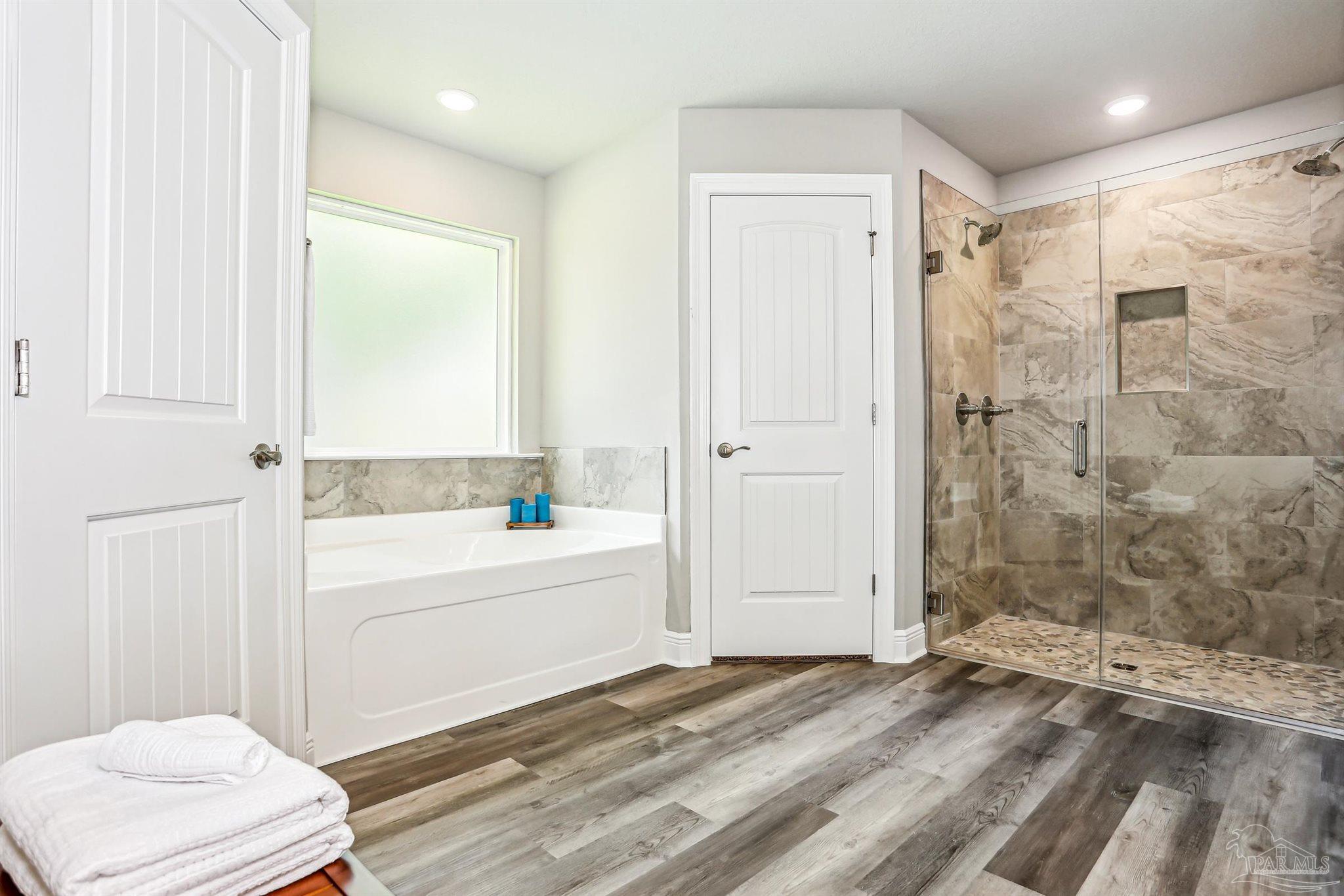 3639 Bob Tolbert Road Navarre, FL 32566 - Photo 19 of 28 a bathroom with a bathtub and a shower