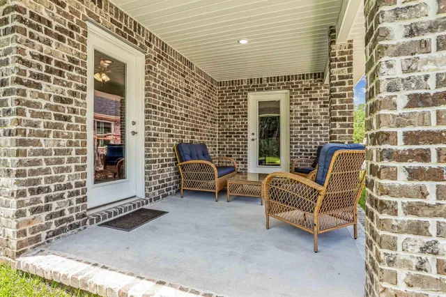 a view of a patio with a couch and a table and chair