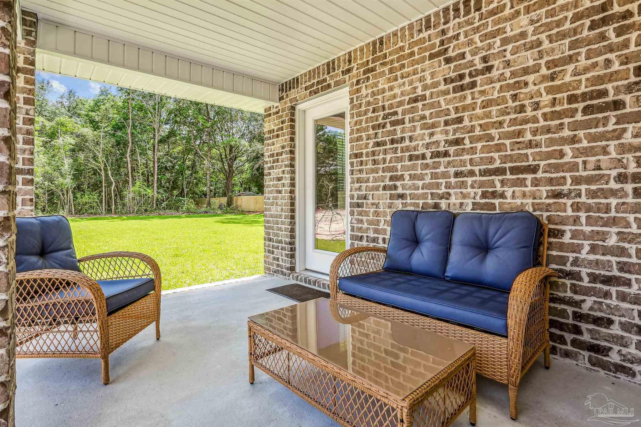 3639 Bob Tolbert Road Navarre, FL 32566 - Photo 28 of 28 a outdoor living space with furniture and a garden