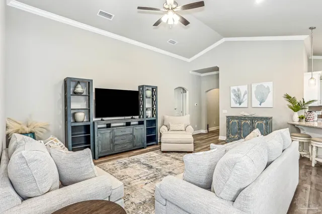 a living room with furniture and a flat screen tv