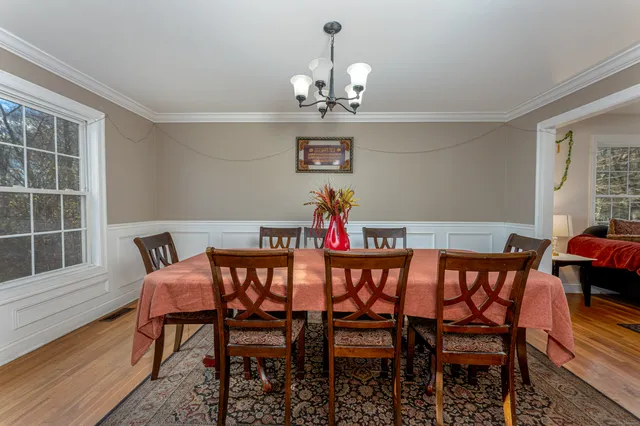 a view of a dining room with furniture wooden floor and chandelier
