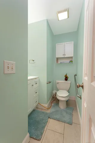 a white toilet sitting next to a bathroom sink