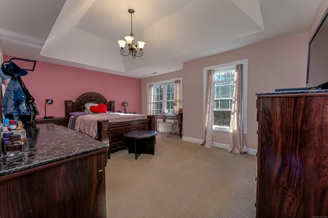 a living room with furniture a chandelier and a window