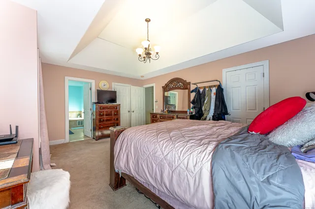 a bed room with a bed and a chair