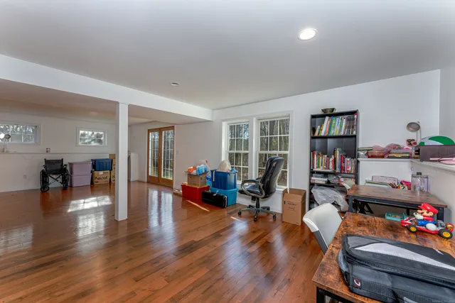 a living room with furniture and wooden floor