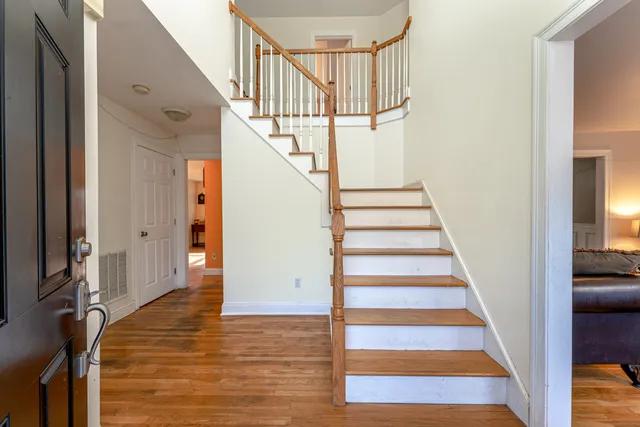 a view of entryway and hall with wooden floor